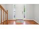 Bright foyer with hardwood floors and a staircase, showcasing a welcoming entrance at 7388 Wythe Dr, Noblesville, IN 46062