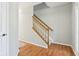 Hallway featuring wood floors, a stairway with carpet, and natural lighting at 7388 Wythe Dr, Noblesville, IN 46062