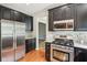 Kitchen with stainless steel appliances, granite countertops, and dark wood cabinetry at 7388 Wythe Dr, Noblesville, IN 46062