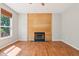 Bright living room features a wood accent wall with fireplace and large window at 7388 Wythe Dr, Noblesville, IN 46062