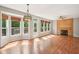 Spacious living room with a fireplace, large windows, and hardwood floors at 7388 Wythe Dr, Noblesville, IN 46062
