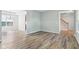 Open floor plan: spacious living room boasts modern chandelier, hardwood floors, and sunlit windows at 7388 Wythe Dr, Noblesville, IN 46062