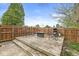 Backyard deck with gas grill, fire pit, and outdoor seating area surrounded by wood fence at 745 N Madison St, Fortville, IN 46040