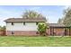 Expansive backyard featuring pergola with seating, lush lawn, and well maintained exterior at 745 N Madison St, Fortville, IN 46040