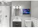 Well-lit bathroom featuring modern vanity, shower, and decorative artwork at 745 N Madison St, Fortville, IN 46040
