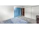 Comfortable bedroom with neutral tones, closet space, and calming blue accent wall at 745 N Madison St, Fortville, IN 46040