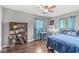 Bedroom features wooden floors, blue curtains and a modern desk at 745 N Madison St, Fortville, IN 46040