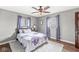 A bedroom with hardwood floors, a ceiling fan, and two windows at 745 N Madison St, Fortville, IN 46040