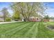 Charming front yard with manicured lawn, mature trees, and a well-maintained home at 745 N Madison St, Fortville, IN 46040