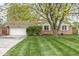 Charming brick home featuring a well-manicured lawn and mature trees, enhancing its curb appeal at 745 N Madison St, Fortville, IN 46040