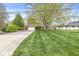 A home with a brick facade, well manicured lawn and large front yard at 745 N Madison St, Fortville, IN 46040