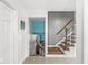 Bright hallway featuring stairs to the lower level and stylish decor, enhancing the home's charm at 745 N Madison St, Fortville, IN 46040