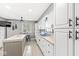 A kitchen featuring white cabinets, tile countertops, and an adjacent breakfast nook at 745 N Madison St, Fortville, IN 46040