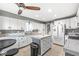 Bright kitchen with white cabinetry, an island, and modern appliances, perfect for culinary enthusiasts at 745 N Madison St, Fortville, IN 46040