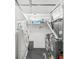 Functional laundry room with appliances, storage shelves, and organized supplies at 745 N Madison St, Fortville, IN 46040
