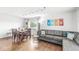 Inviting living room with a comfortable gray sectional sofa and a dining table, perfect for relaxation and entertaining at 745 N Madison St, Fortville, IN 46040