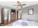 A main bedroom showcasing a dresser, ceiling fan, and ensuite bathroom at 745 N Madison St, Fortville, IN 46040