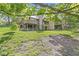 Lush green backyard featuring mature trees and a raised deck with an entertainment area at 8047 Van Ness Way, Indianapolis, IN 46240