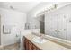 Bright bathroom with a long countertop, mirror, and white cabinets at 8047 Van Ness Way, Indianapolis, IN 46240