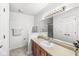 Well-lit bathroom with a vanity, large mirror, and linen closet at 8047 Van Ness Way, Indianapolis, IN 46240