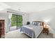 Bright bedroom with backyard access, a comfortable bed, and a soothing color palette at 8047 Van Ness Way, Indianapolis, IN 46240