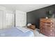 Cozy bedroom with a dark accent wall, comfortable carpeting, and lots of storage space at 8047 Van Ness Way, Indianapolis, IN 46240