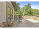 Expansive deck featuring outdoor seating overlooking mature trees and manicured lawn at 8047 Van Ness Way, Indianapolis, IN 46240
