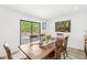 Dining room with sliding glass doors to deck and a rustic wood table at 8047 Van Ness Way, Indianapolis, IN 46240