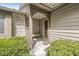 Inviting covered front porch with seating, stone accents, and manicured bushes at 8047 Van Ness Way, Indianapolis, IN 46240
