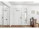 Welcoming foyer with mirrored closet doors, transom window, and stylish details at 8047 Van Ness Way, Indianapolis, IN 46240