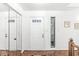 Bright foyer features a mirrored closet door, front door with glass inserts, and beautiful parquet floors at 8047 Van Ness Way, Indianapolis, IN 46240