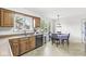 Bright eat-in kitchen featuring wooden cabinets, a double sink, and natural light at 8047 Van Ness Way, Indianapolis, IN 46240