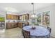 Eat-in kitchen with a dining table, traditional wood cabinetry, and bright lighting at 8047 Van Ness Way, Indianapolis, IN 46240