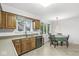 Bright kitchen features wood cabinets, stainless steel appliances, and an adjacent dining area with natural light at 8047 Van Ness Way, Indianapolis, IN 46240