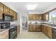 Well-lit kitchen featuring lots of cabinet space and black appliances at 8047 Van Ness Way, Indianapolis, IN 46240