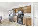 Efficient kitchen with stainless steel refrigerator and sleek black appliances at 8047 Van Ness Way, Indianapolis, IN 46240