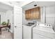 Bright laundry room featuring a modern washer and dryer set with upper cabinets at 8047 Van Ness Way, Indianapolis, IN 46240