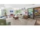 Inviting living room with white walls, neutral carpeting, and large windows offering plenty of natural light at 8047 Van Ness Way, Indianapolis, IN 46240