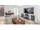 Spacious living room with plush carpet, large TV, and comfortable seating area at 8047 Van Ness Way, Indianapolis, IN 46240