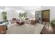 Bright living room featuring neutral carpet, a sliding glass door to the outdoors, and comfortable couches at 8047 Van Ness Way, Indianapolis, IN 46240