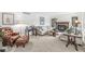 Comfortable living room with neutral tones, cozy seating, fireplace, and abundant natural light at 8047 Van Ness Way, Indianapolis, IN 46240