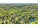 This secluded property features mature trees and includes a pond, as seen from an aerial view at 8820 Mud Creek Rd, Indianapolis, IN 46256