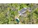 Lush backyard with pool, surrounded by trees, complements this charming home at 8820 Mud Creek Rd, Indianapolis, IN 46256