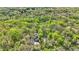 This secluded property features mature trees and includes a pool, as seen from an aerial view at 8820 Mud Creek Rd, Indianapolis, IN 46256
