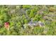 Secluded home features an in-ground pool surrounded by mature trees on a spacious lot at 8820 Mud Creek Rd, Indianapolis, IN 46256