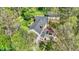 Aerial view of a charming home with lush trees, deck, and patio offering a serene and inviting outdoor living space at 8820 Mud Creek Rd, Indianapolis, IN 46256