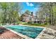 Expansive backyard with pool and mature trees creating privacy and seclusion at 8820 Mud Creek Rd, Indianapolis, IN 46256
