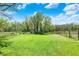 Backyard showcasing a vast lawn and mature trees, creating a serene outdoor space at 8820 Mud Creek Rd, Indianapolis, IN 46256