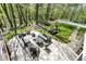 Aerial view of the backyard featuring a patio, pool, firepit, and lush greenery at 8820 Mud Creek Rd, Indianapolis, IN 46256
