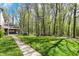 Lush backyard with a stone walkway leading to a charming house, perfect for peaceful outdoor enjoyment at 8820 Mud Creek Rd, Indianapolis, IN 46256